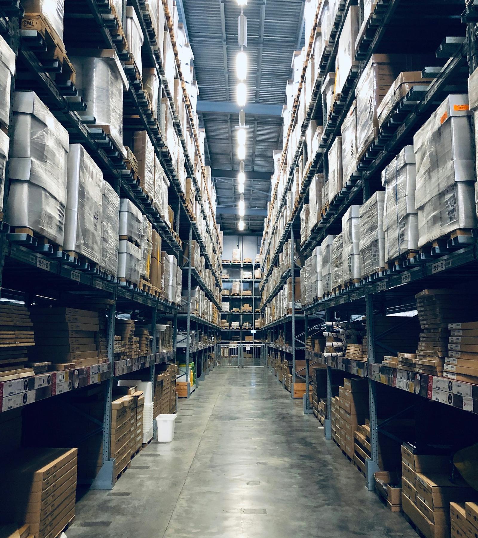 Pasillo de almacén con estanterías altas